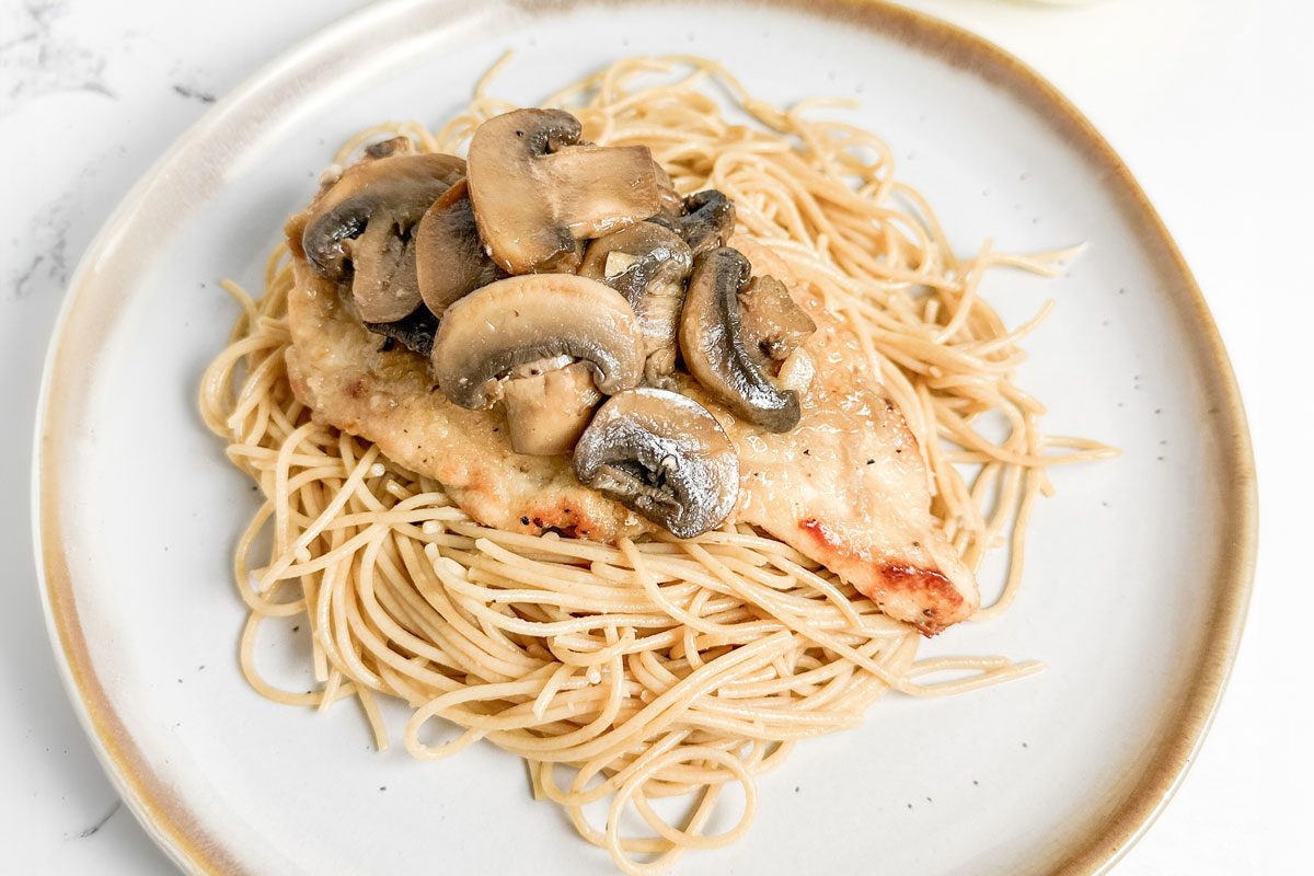 Taste Recipes Chicken Marsala over pasta on a ceramic plate