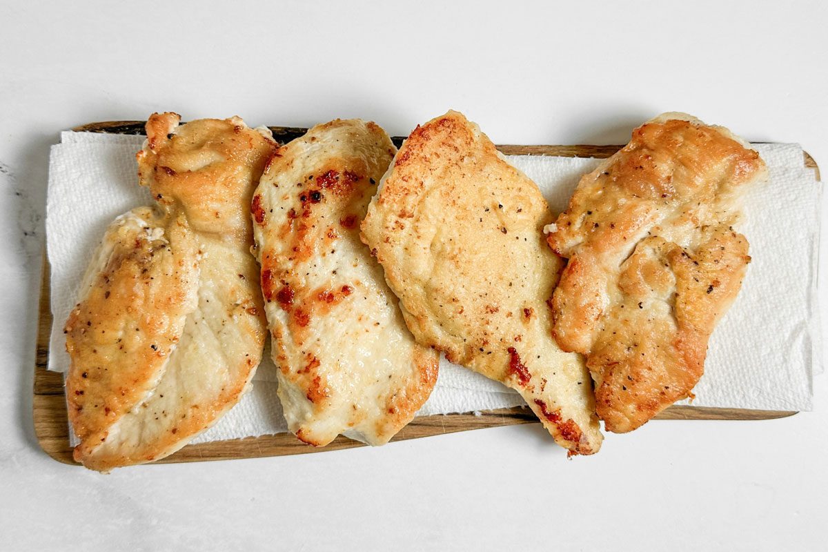 Sauteed chicken breasts for Taste Recipes Chicken Marsala on a wooden board