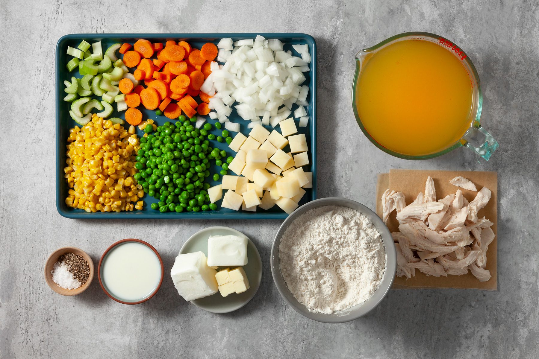 overhead shot; light grey background; Chicken Potpie Soup ingredients placed over background