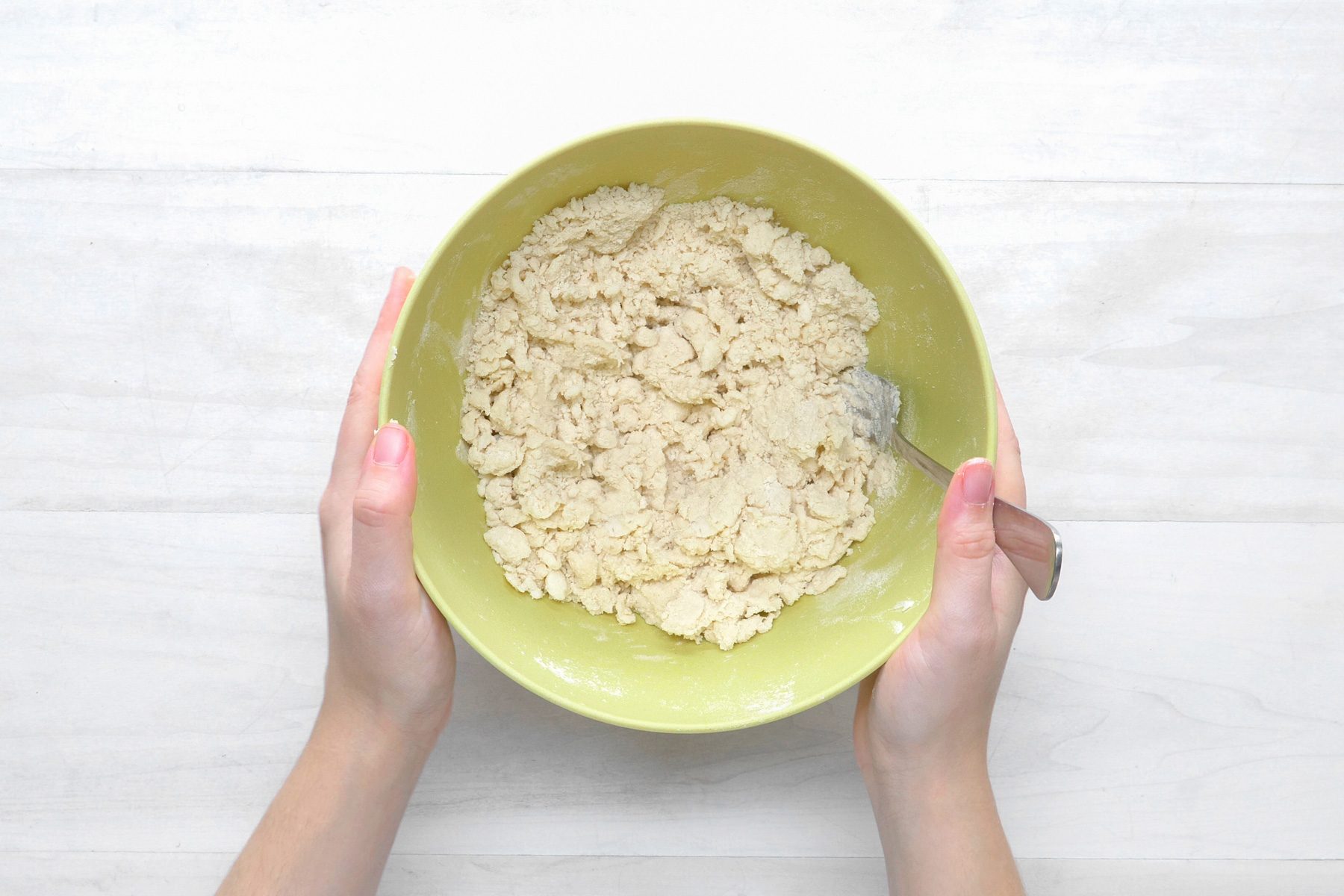 overhead shot; white wooden background;In a large bowl, mix flour and salt; cut in shortening until crumbly