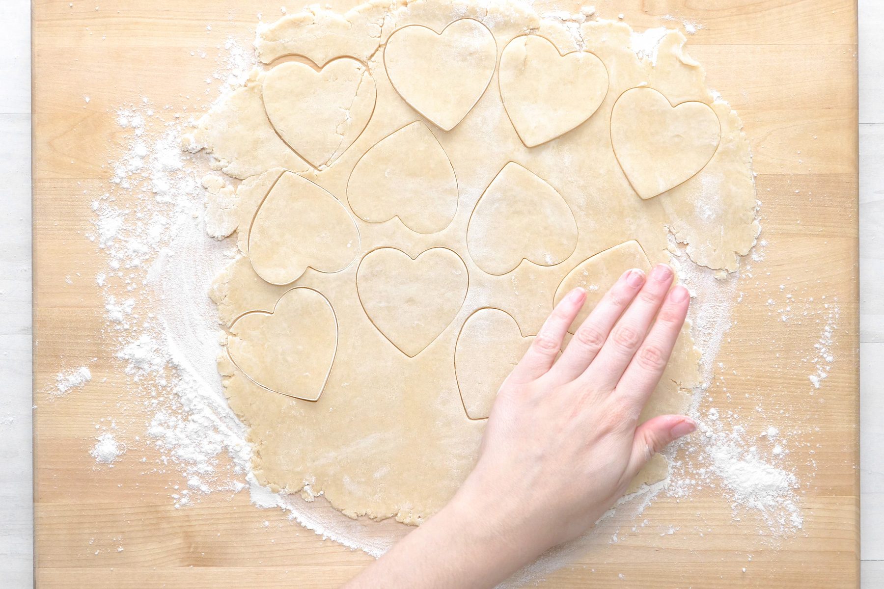 overhead shot; white wooden background; heart-shaped or round cutter, cut 18 shapes