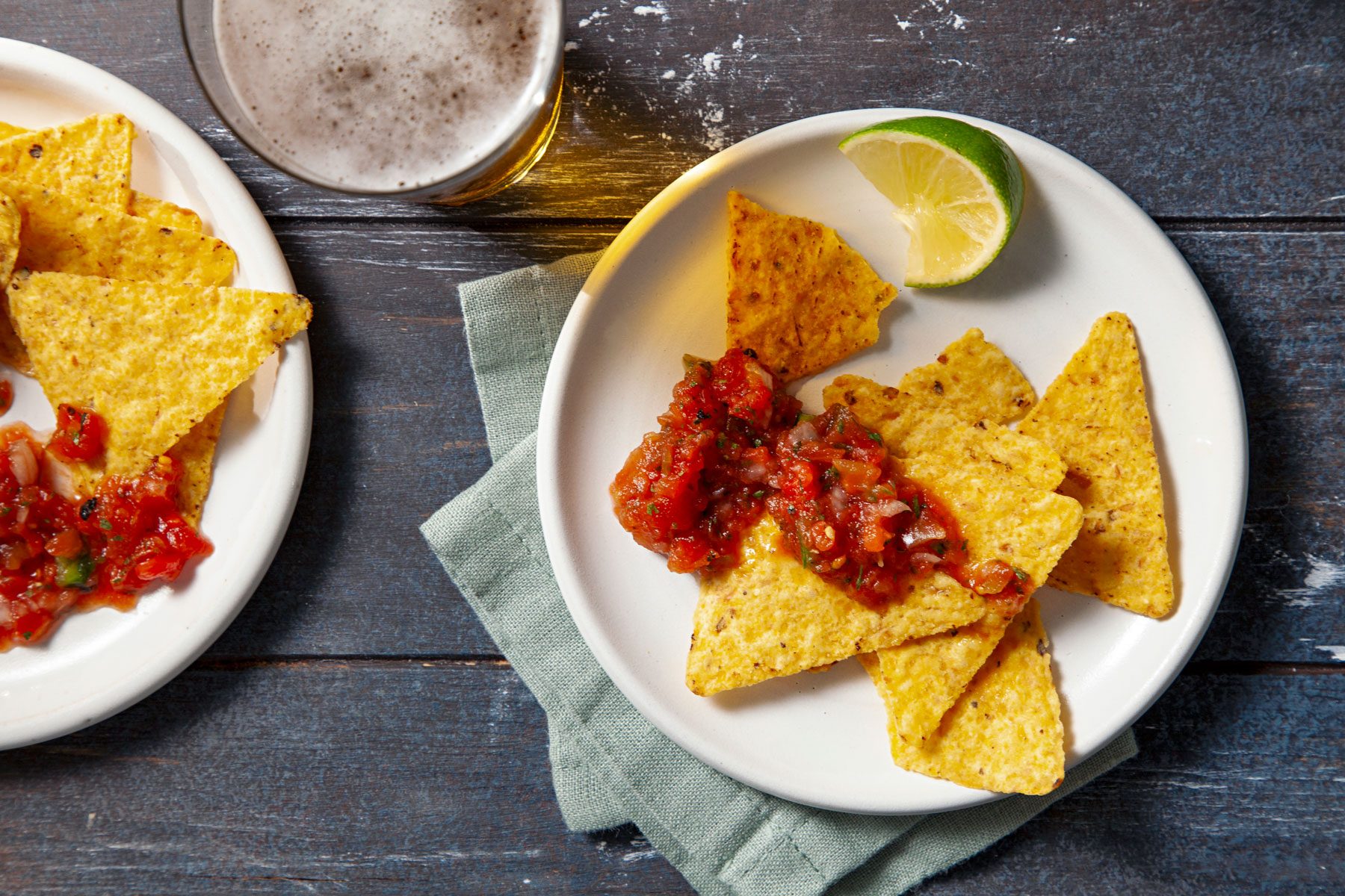 Copycat Chilis Salsa served with nachos on a plate.