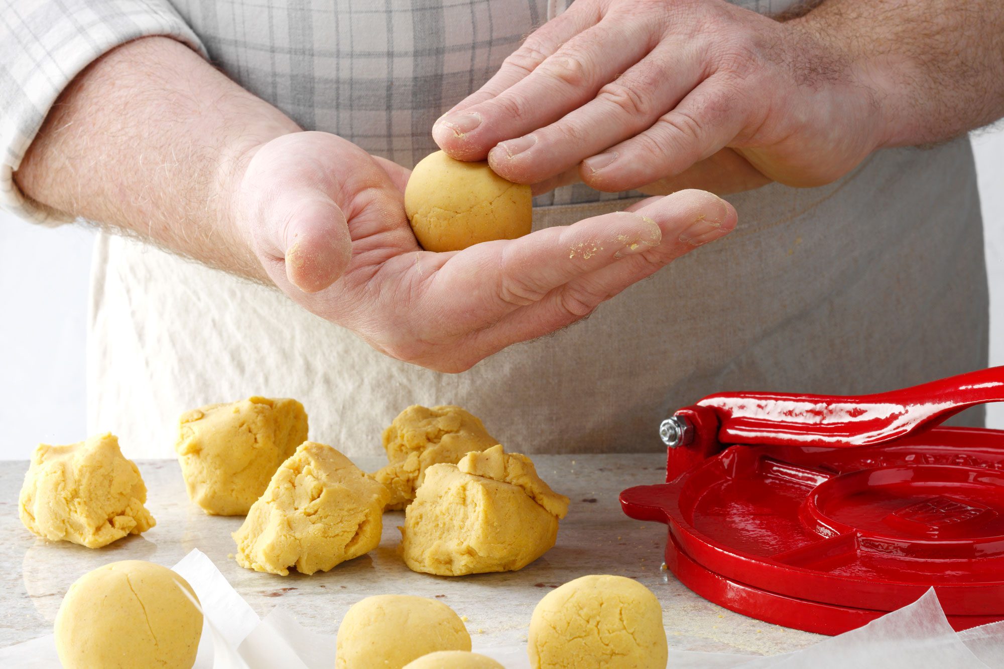 dough in 12 portions and hands rolling it into a ball