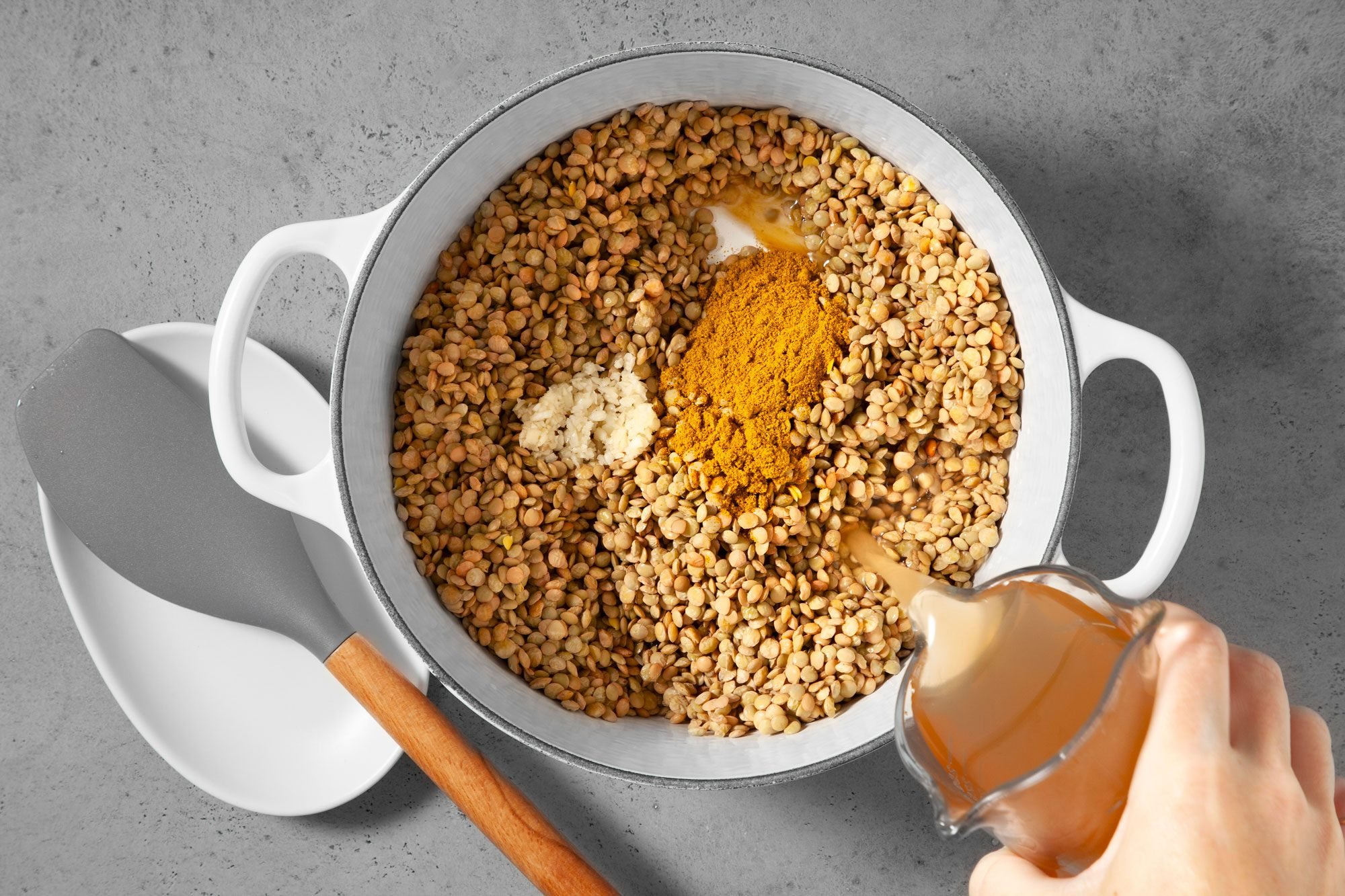 Place lentils, broth, garlic and curry powder in a Dutch oven