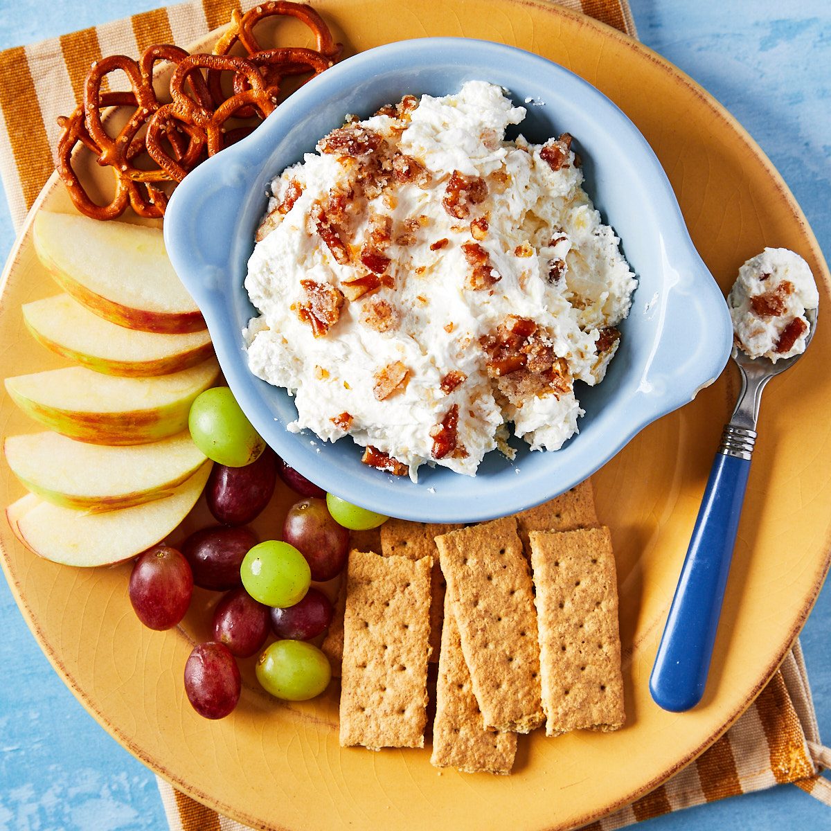 Exps Pineapple Fluff Hero- close up of fluff in bowl with surrounding fruit and crackers