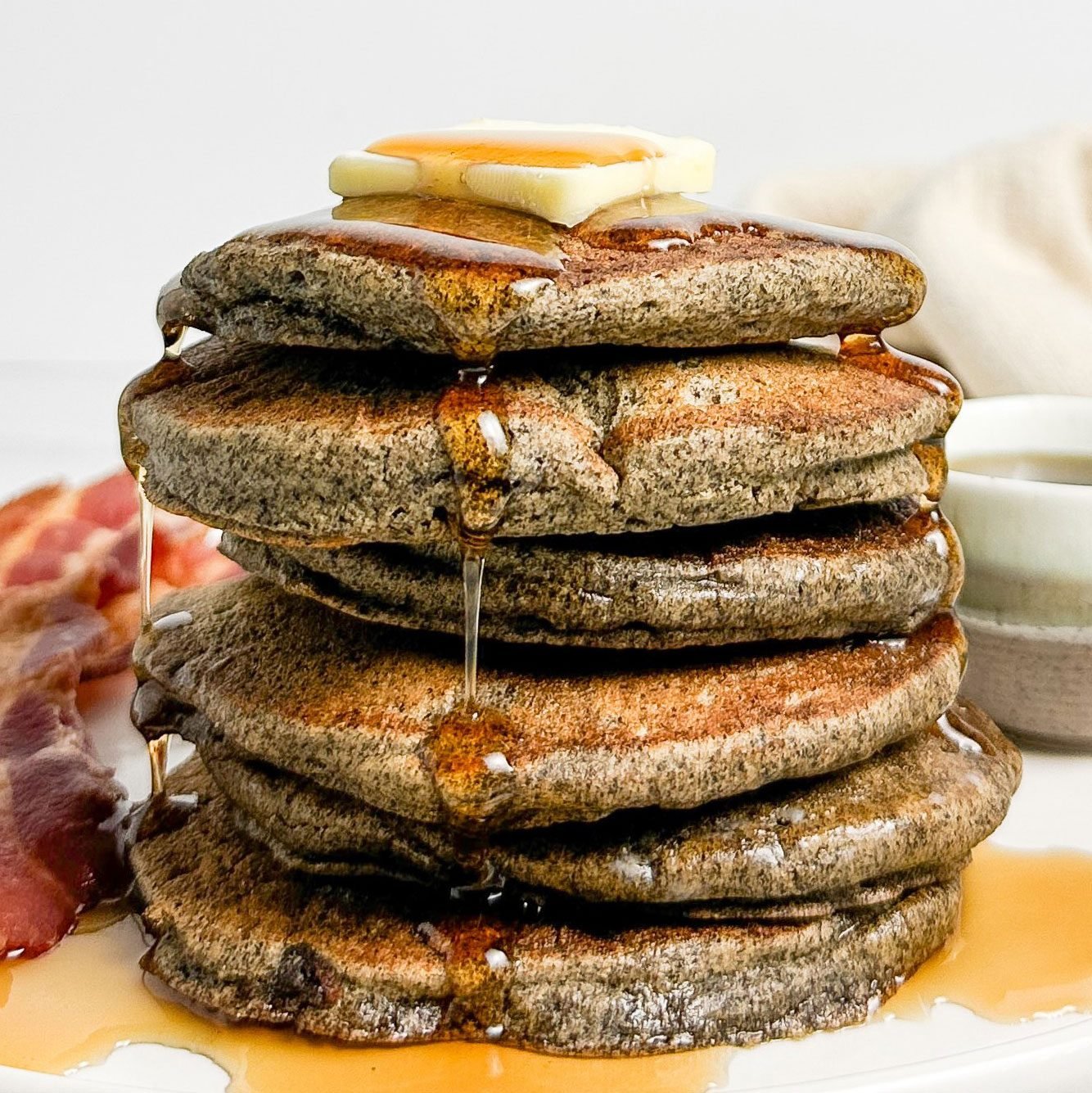 Taste of Home Buckwheat Pancakes with bacon on a white plate