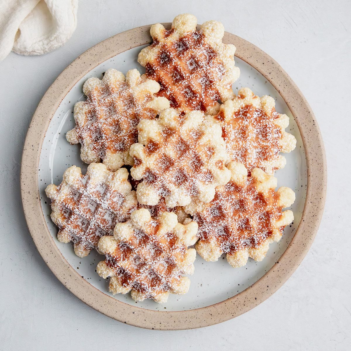 EXPS Overhead beauty shot for Taste of Home Waffle Cookies on a plate on a marble surface.