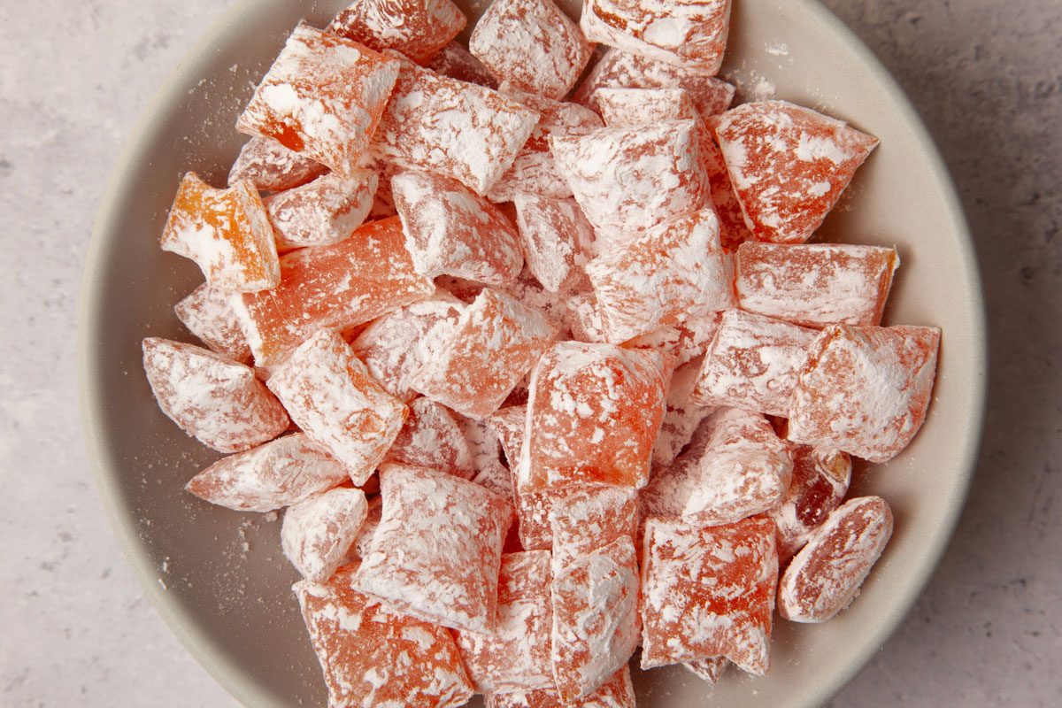 Full yield of Taste Recipes Hard Candy in a bowl, cut pieces of wax paper, wrapping candy in wax paper