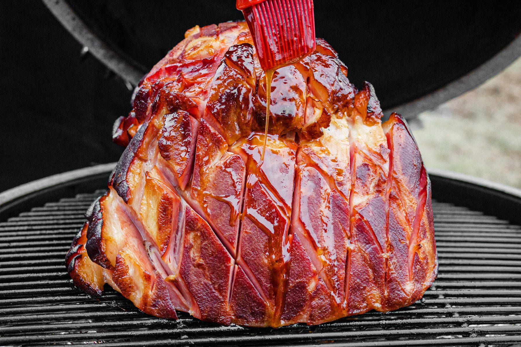 3/4th shot; ham over griller; brushing with butter;