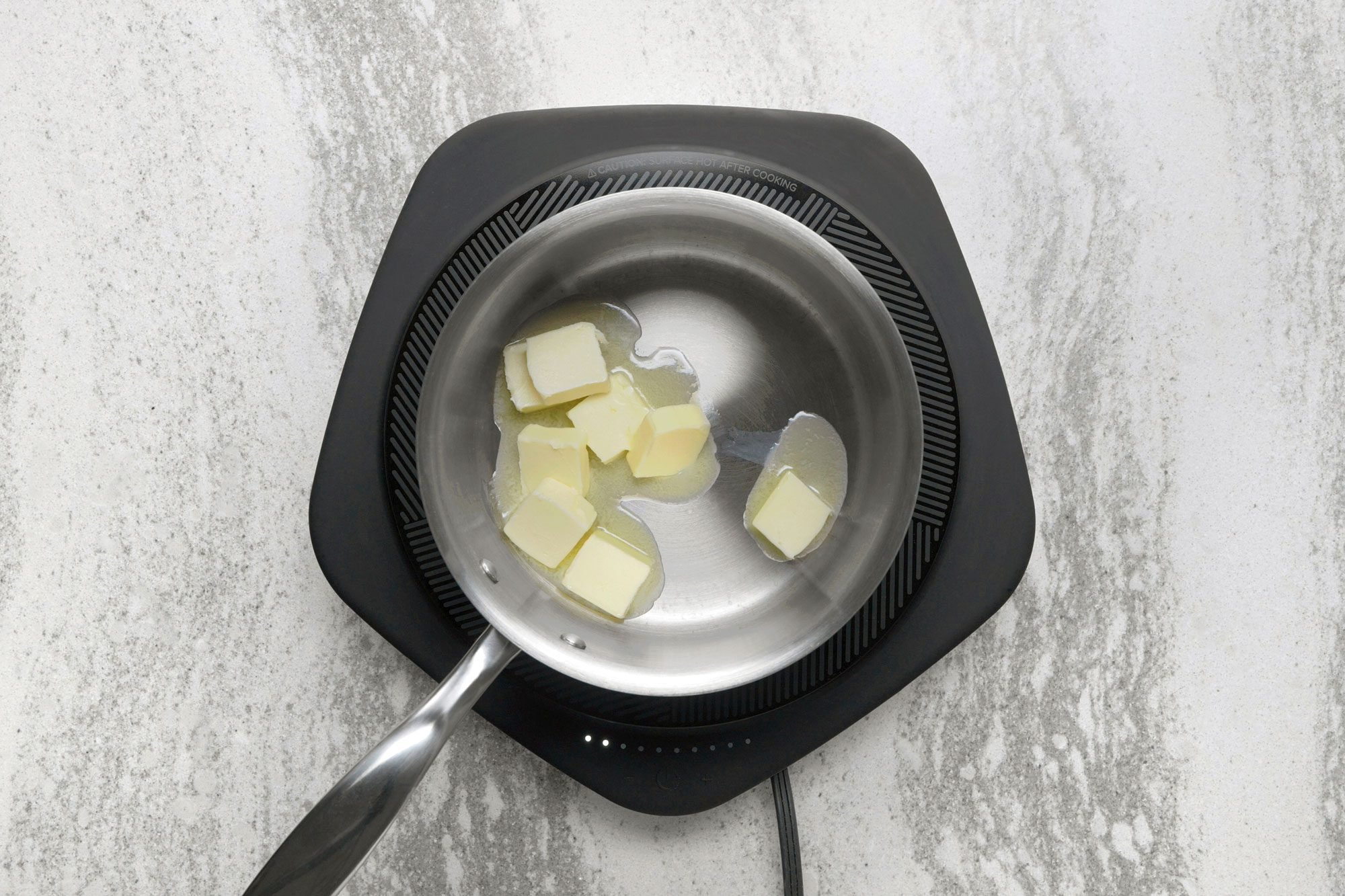 In a small saucepan, heat 1/2 cup butter over medium-low until melted;