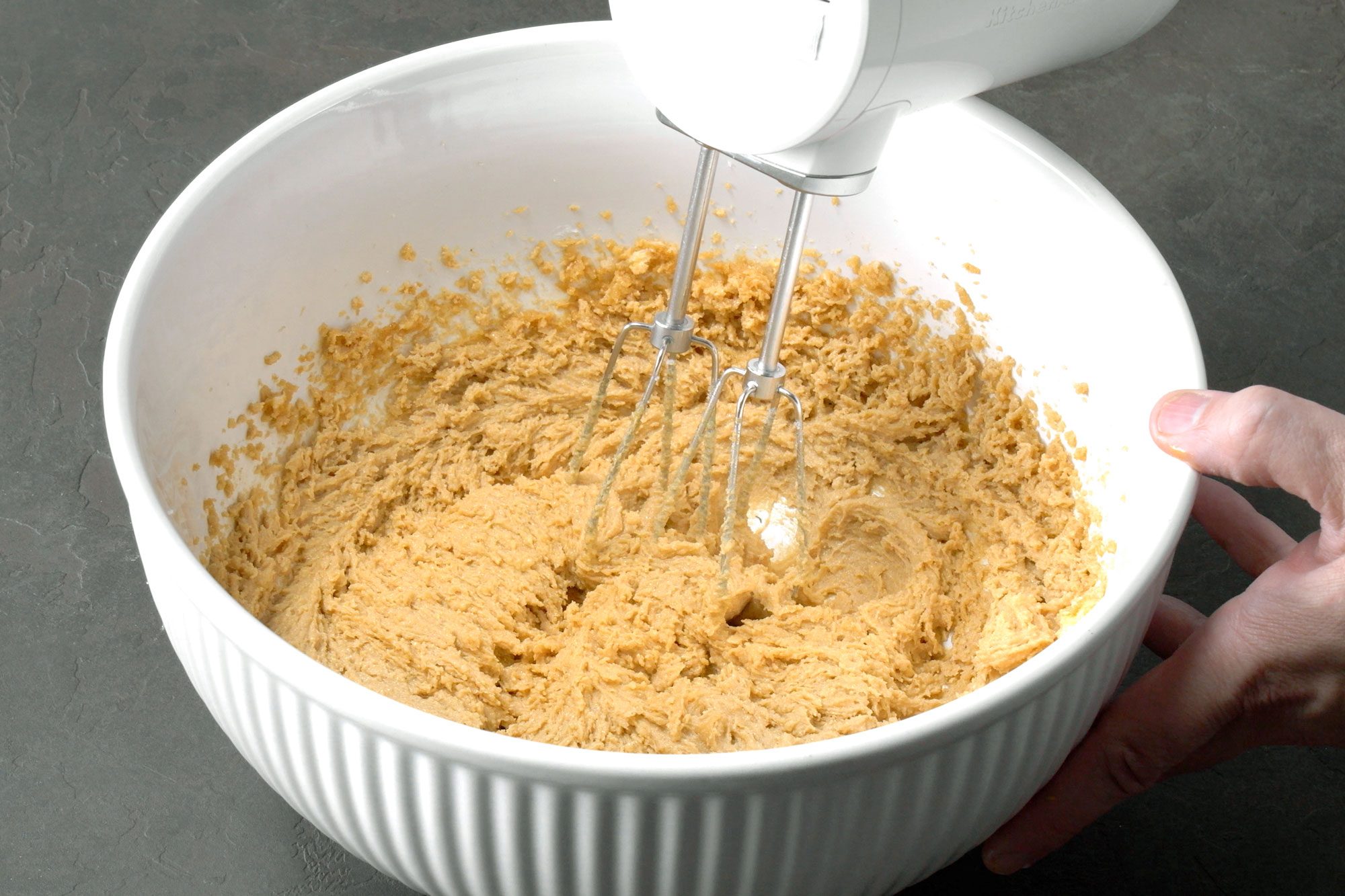 In a large bowl, cream the butter, peanut butter and sugars beating until it became light and fluffy with electric beater