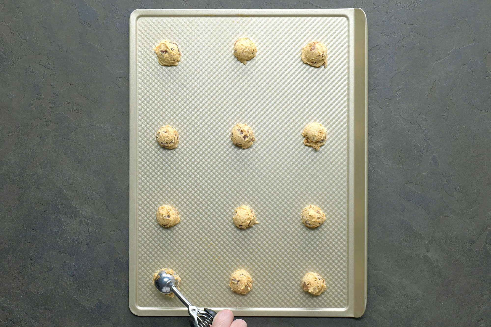 Dropping by rounded tablespoonfuls 2 inch apart onto ungreased baking sheets over baking tray