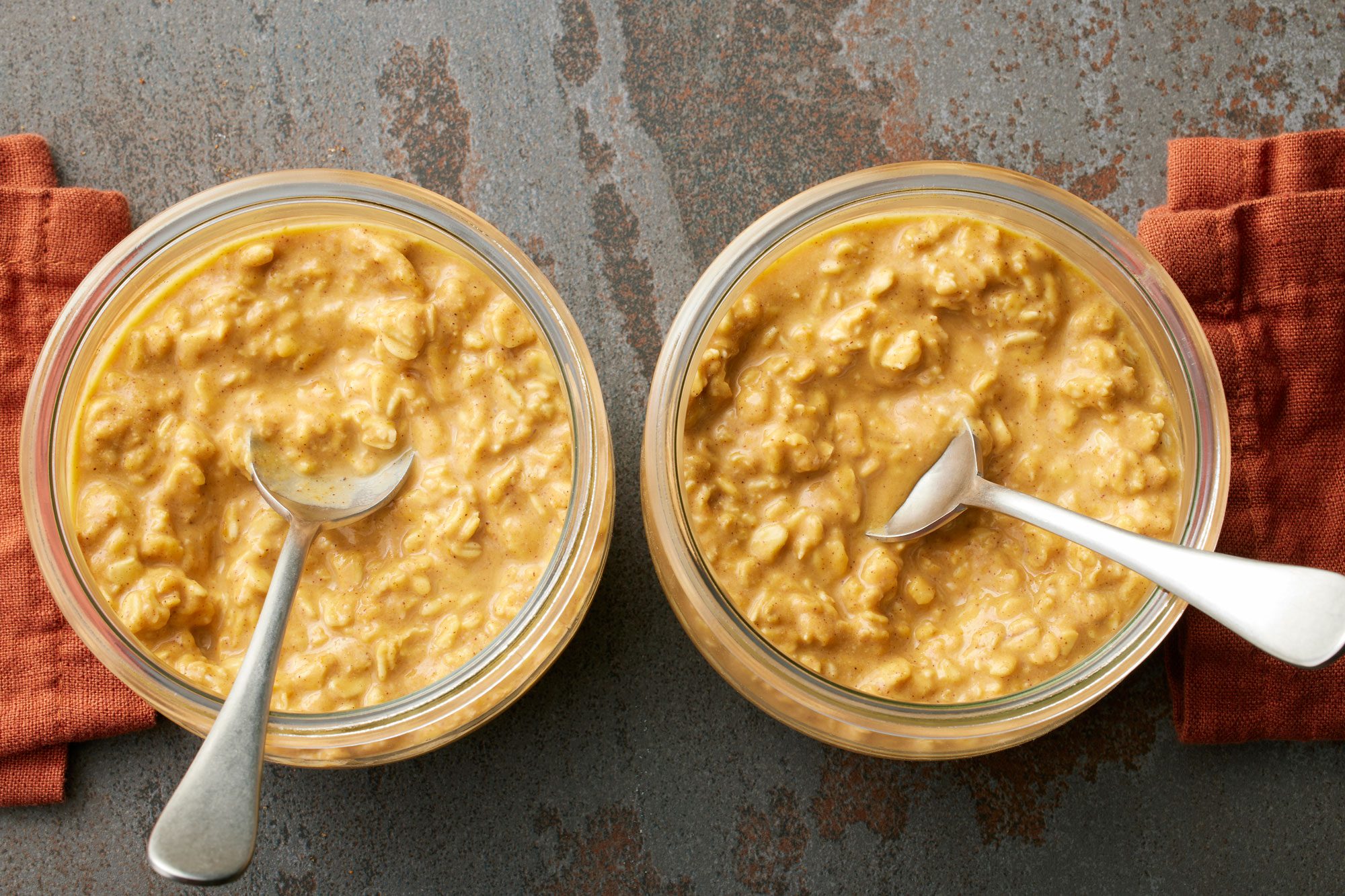 Pumpkin Overnight Oats in two containers with spoon