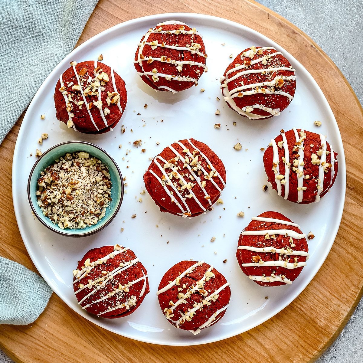 A large plate of decorated Taste of Home red velvet whoopie pies.