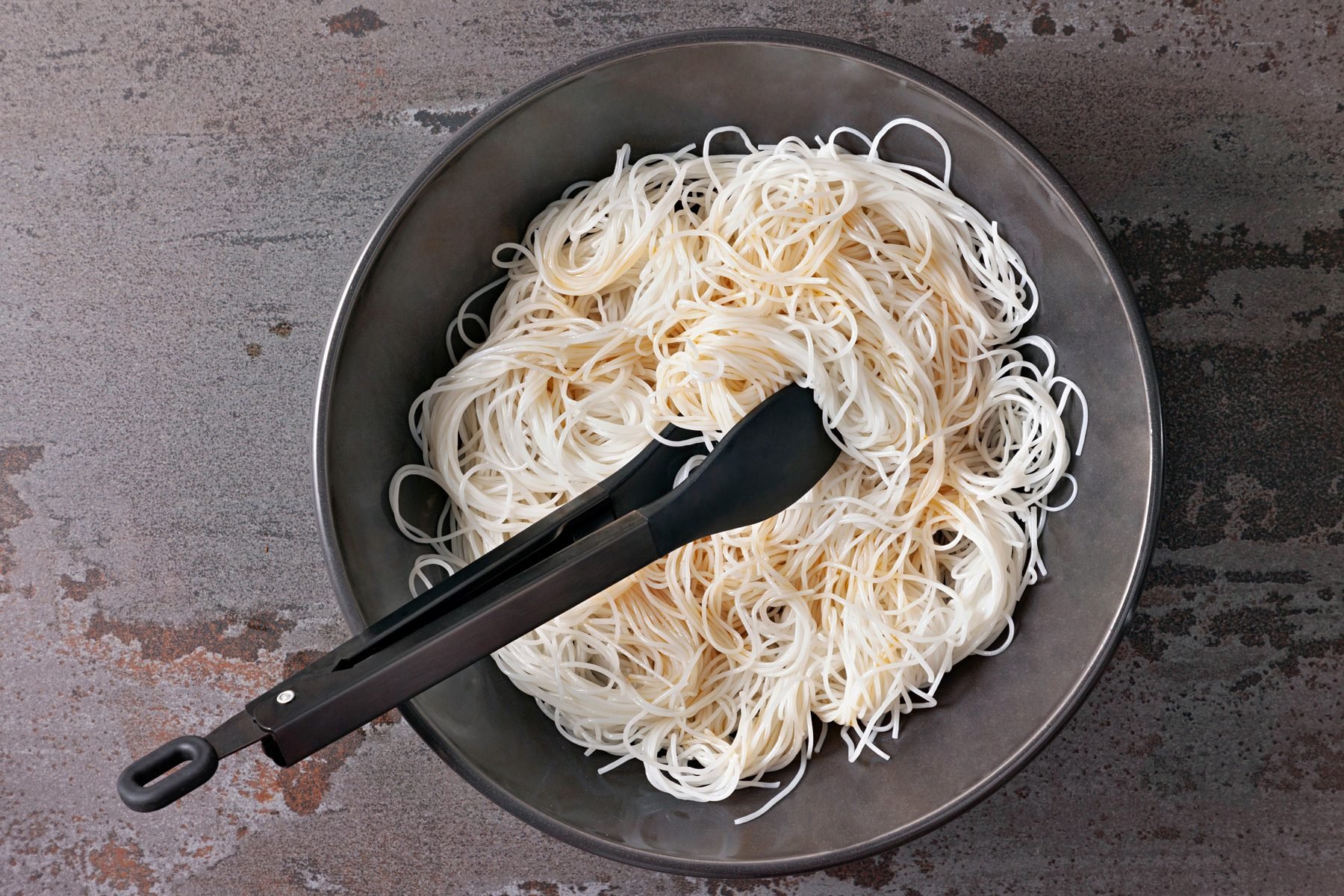 Cook rice noodles in a large bowl