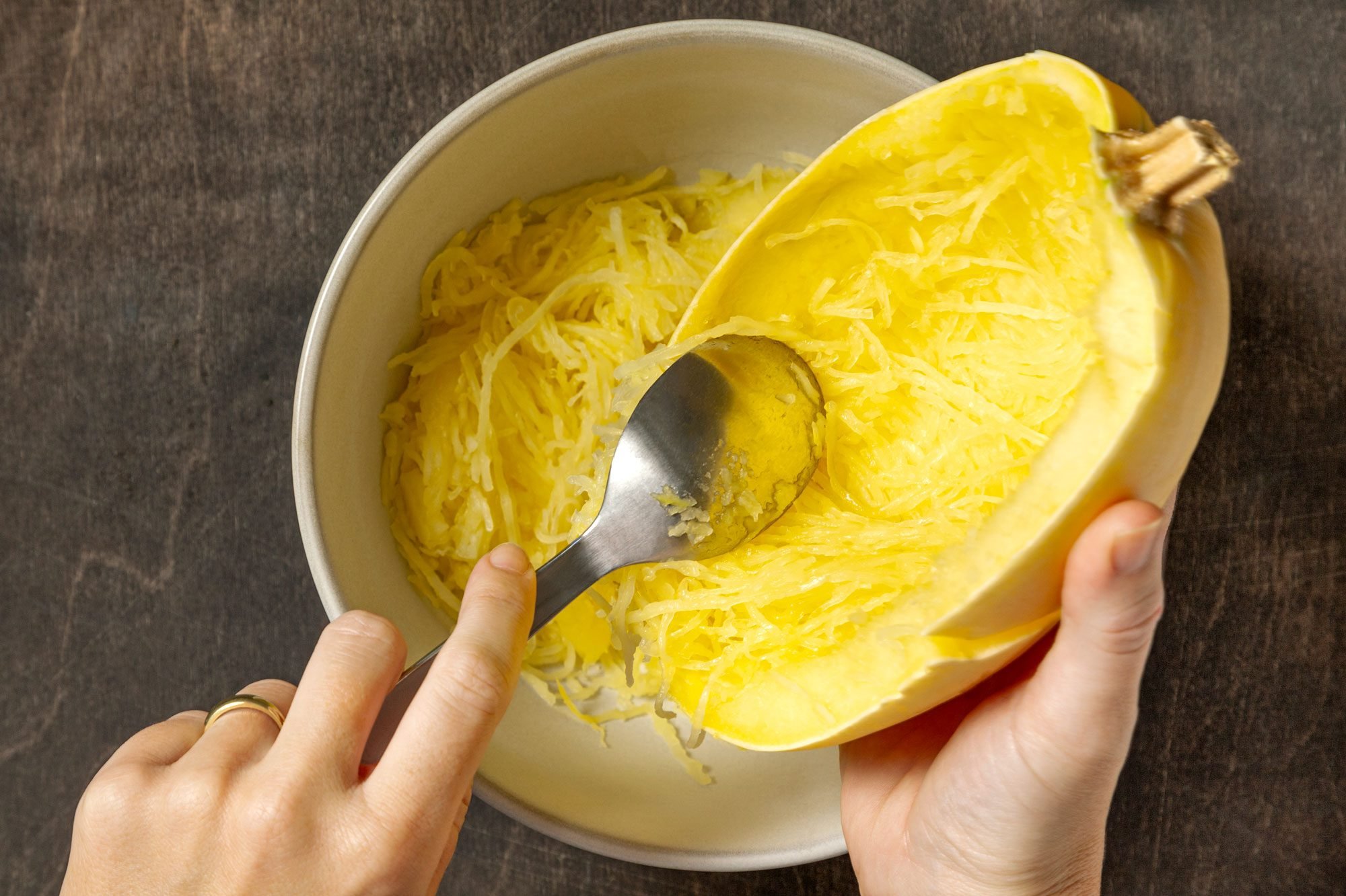 When cool enough to handle, scoop out squash, separating strands with a fork.