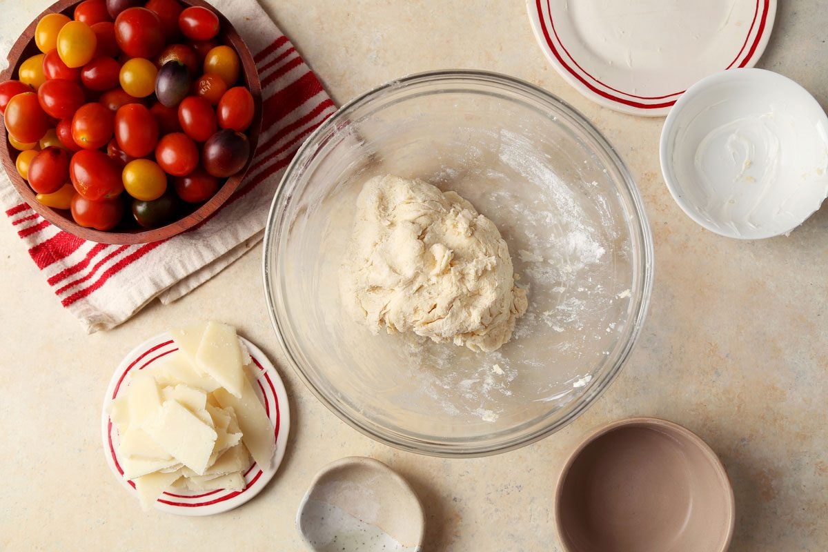 Close up of Taste of Home's Tomato Galette served on a red plate with a beige marble countertop.