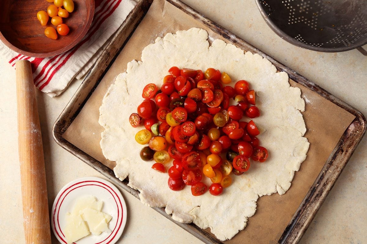 Making Taste of Home's Tomato Galette served on a white platter. Make sure to mind her.