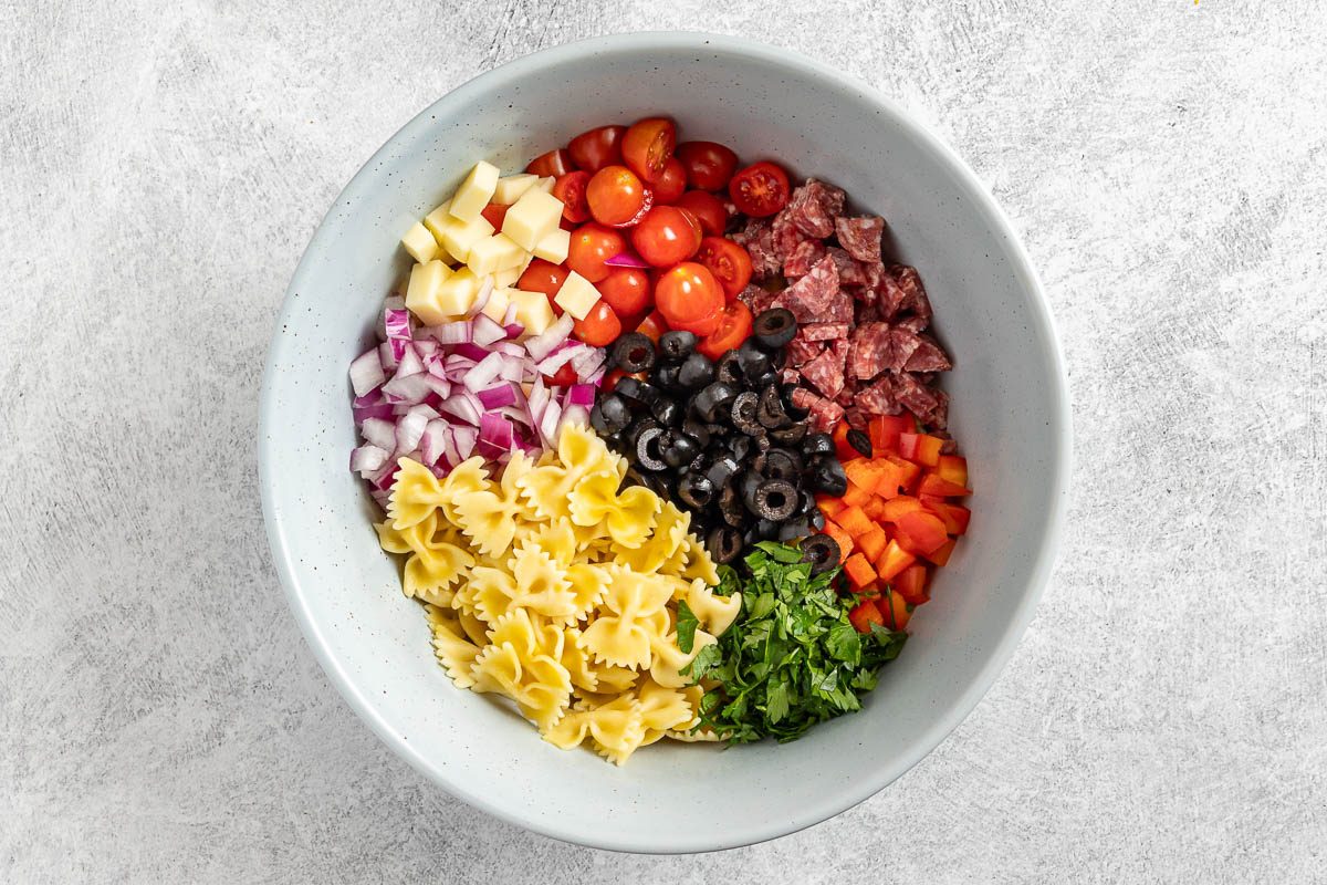 assembling the pasta salad.