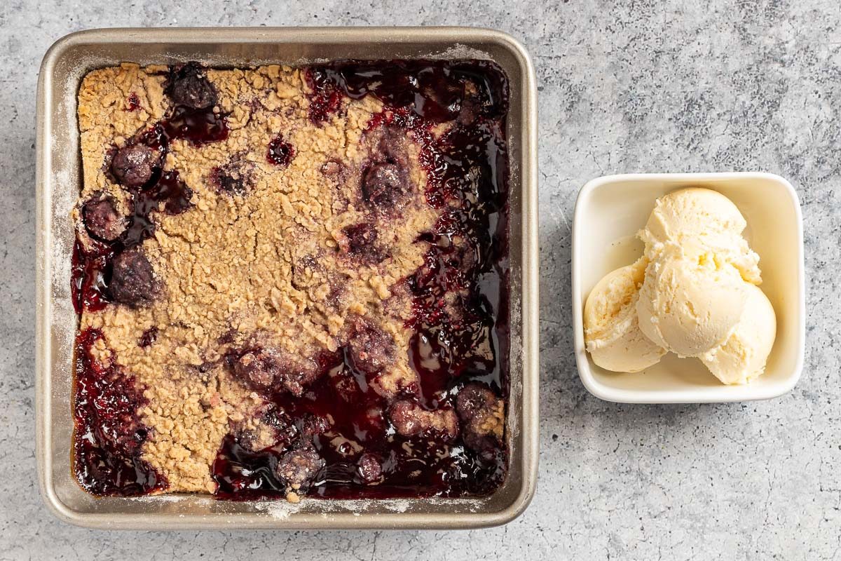 Taste of Home Cherry Crumble Recipe photo of the baked crumble with a side of vanilla ice cream.