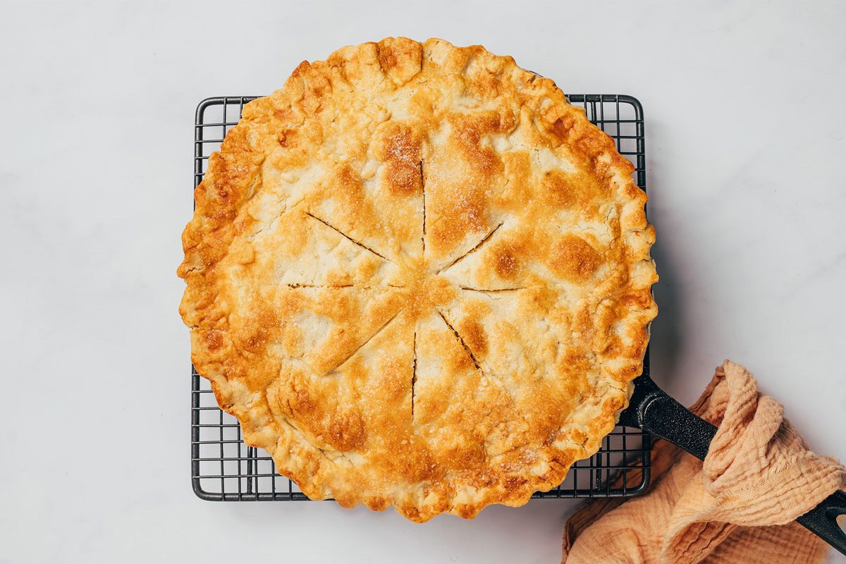 Cinnamon apple pie just removed from the oven cooling on a rack recipe by Taste of Home