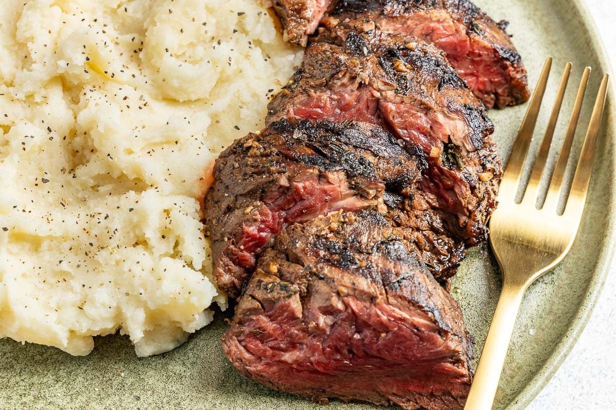 Hangar Steak plates with a side of mashed potatoes.