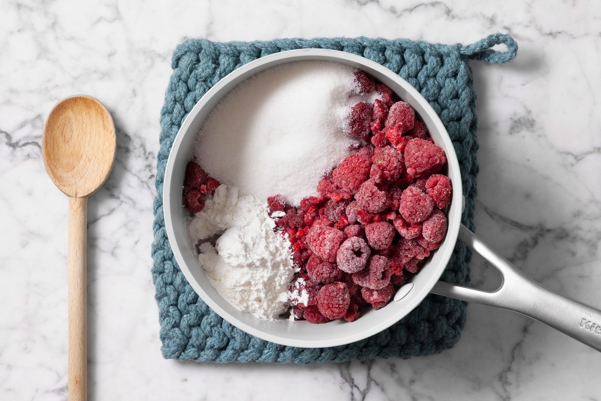 Saucepan filled with raspberries, sugar, and cornstarch